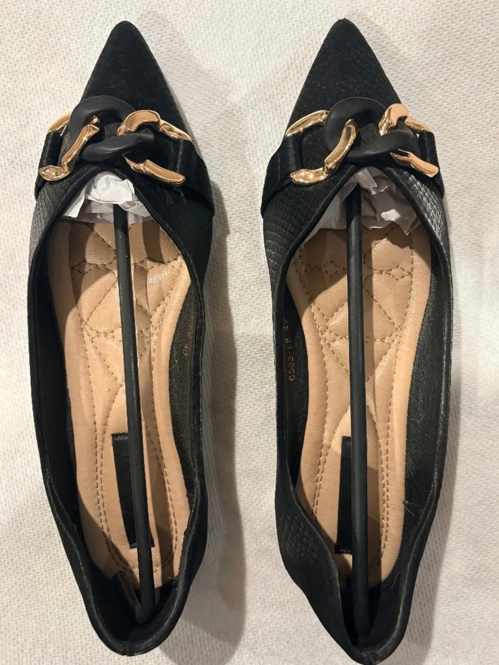 Black flats with gold hardware